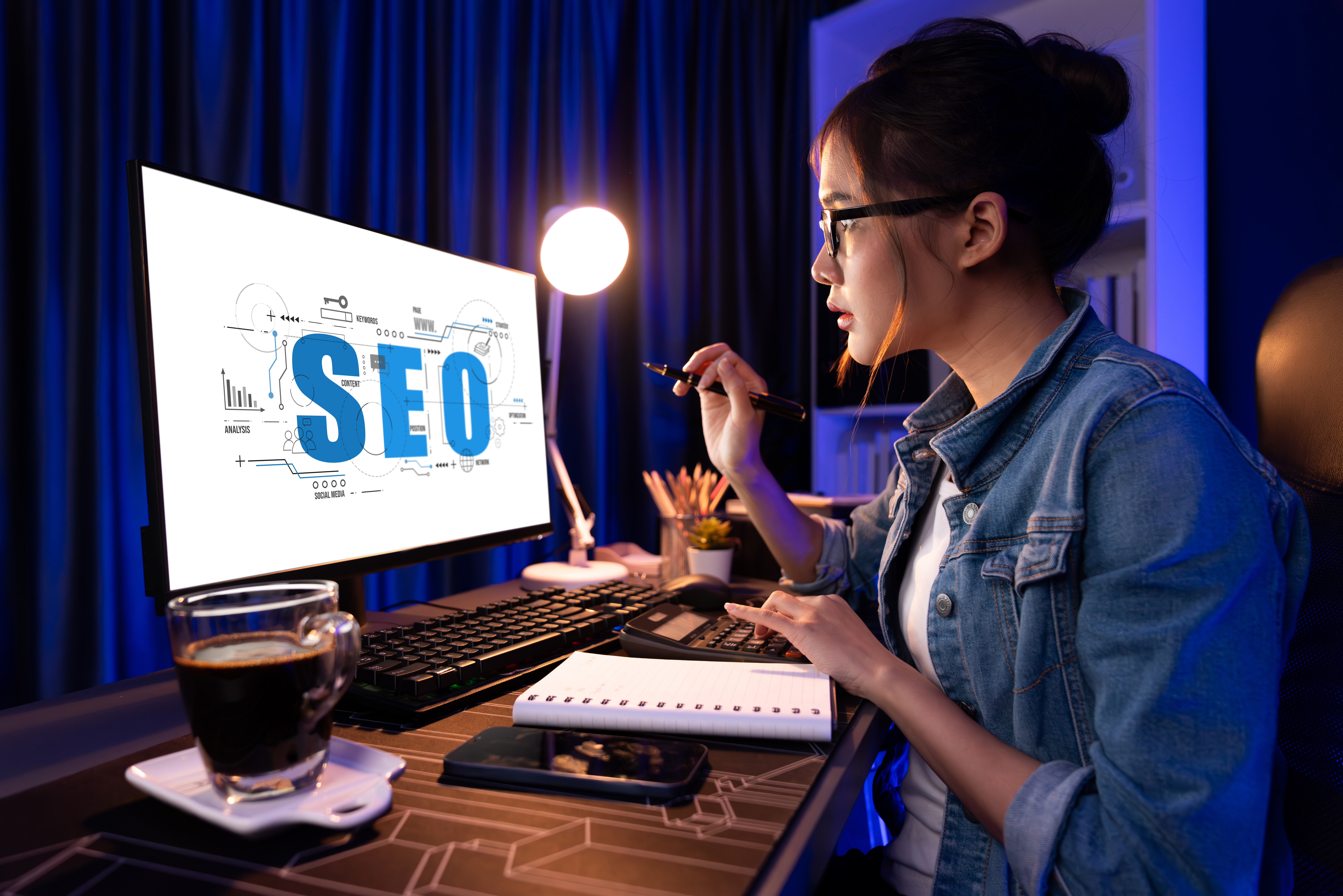 Woman reviewing an SEO diagram on her monitor at a desk